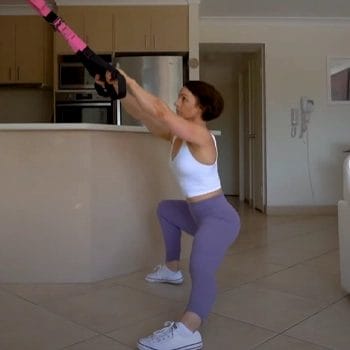 Doing lateral lunge in her home gym
