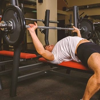 A person doing a bench press in the gym