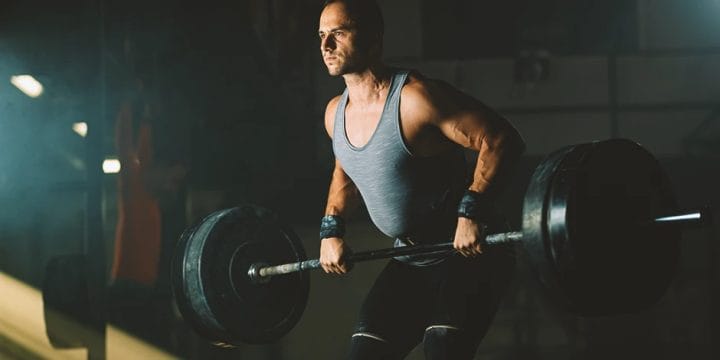 A buff male bulking in the gym