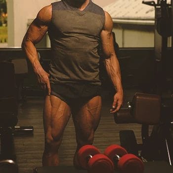 A man is showing muscles while doing the Bulking Workout Plan routine at the gym.