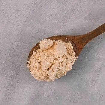Close up shot of creatine on a wooden spoon