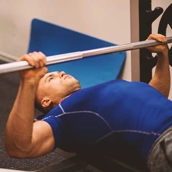A man in the gym doing chest workouts
