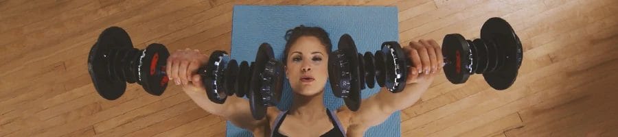 A person doing workouts with bowflex equipment