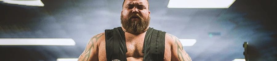 strongman working his back in the gym