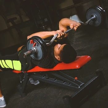 A person doing french press workouts with bowflex equipment