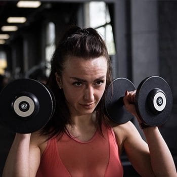 Woman holding two dumbbells