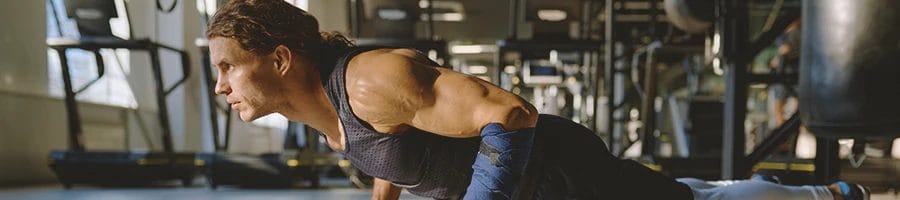 A person doing a push up workout finisher in the gym