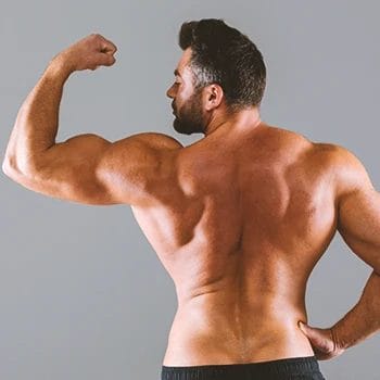 A person flexing his shoulder muscles
