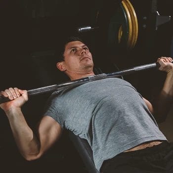 A person doing inclined bench presses in the gym