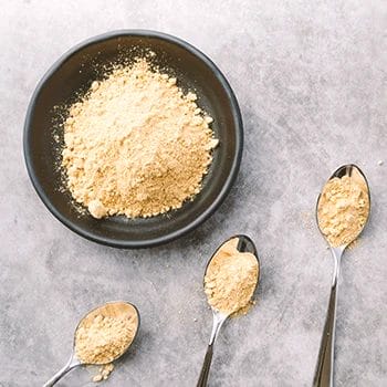 Protein powder on spoons and bowls