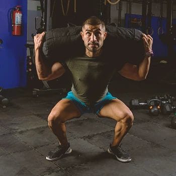 A person doing sandbag leg workouts