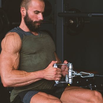 A buff male doing a seated cable rows