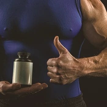 A buff strongman holding supplements