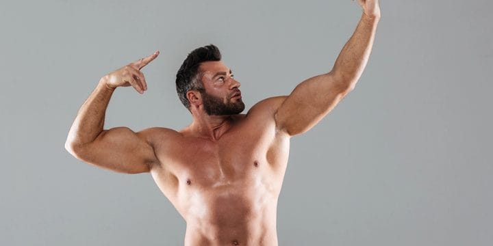 A strong man posing to show muscles