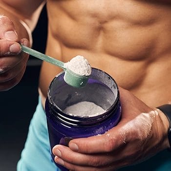 Holding a scoop of a supplement product