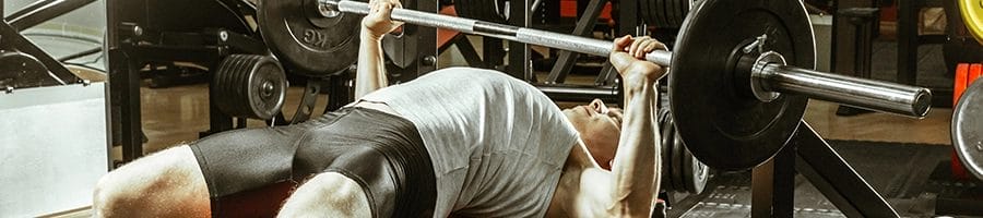 man doing bench press for his full body workout