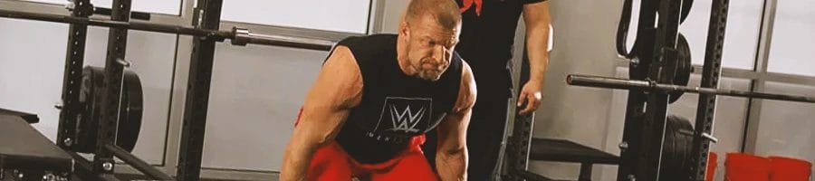 Triple H is doing his workout routine in the gym