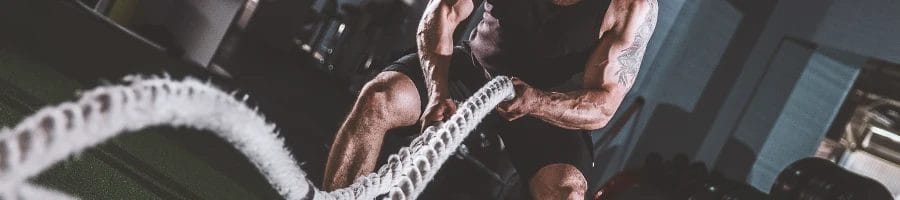 A buff male doing CrossFit in the gym
