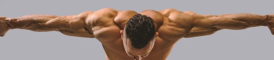 A person flexing his shoulder and arm muscles