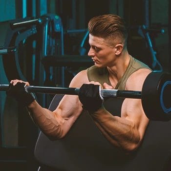 A person doing barbell curls in the gym