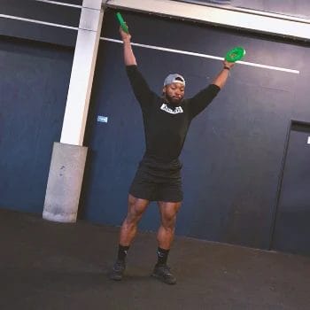 A person doing Y raises in the gym