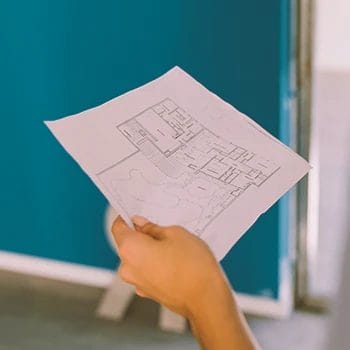 A person holding a floor plan