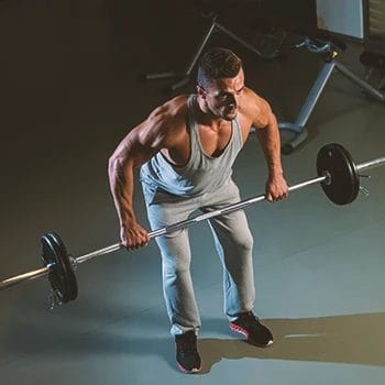 A person doing barbell bent over row workouts in the gym
