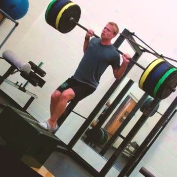 A person doing a barbell step-up