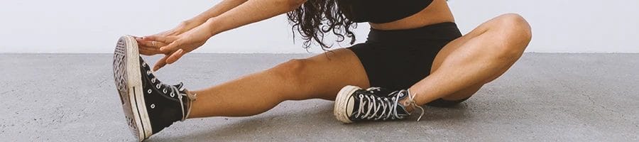 A person stretching out her leg muscles