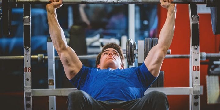 A person in the gym doing the best upper body compound workouts
