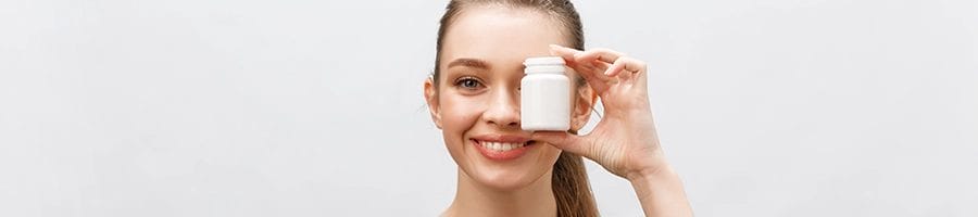 Woman showing a supplement product