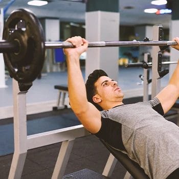 A person doing bench presses in the gym