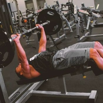 A person doing decline barbell presses in the gym
