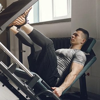 Doing leg press exercises