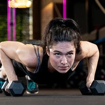 Doing dumbbell burpees