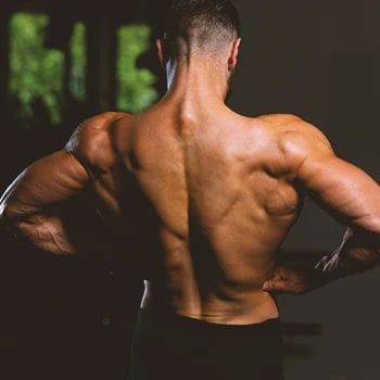 A person flexing back muscles in the gym