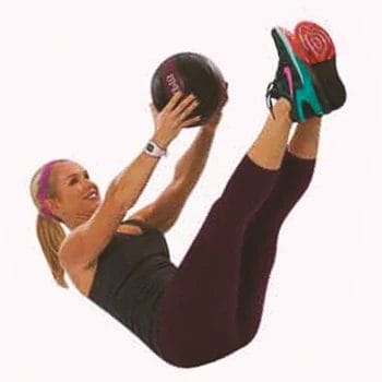 A person doing V-ups with a medicine ball