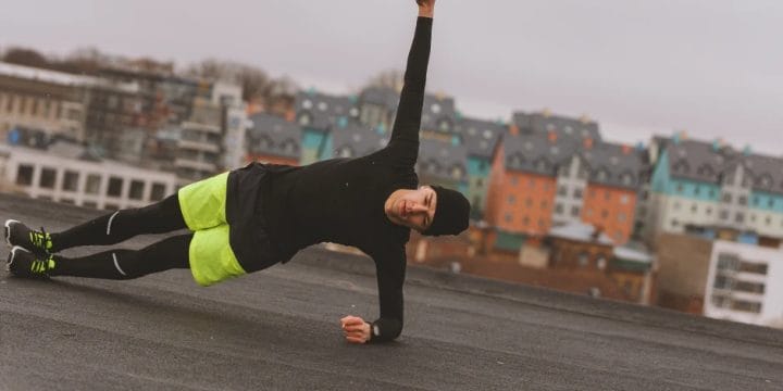 A person doing ballistic stretches for workouts outside